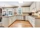 Well-lit kitchen featuring custom cabinetry, granite countertops, and stainless steel appliances at 111 Biltmore Trce, Peachtree City, GA 30269