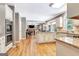 Open concept kitchen with hardwood floors, granite countertops, and access to the living areas at 111 Biltmore Trce, Peachtree City, GA 30269