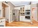 Spacious kitchen featuring a stainless steel refrigerator, double ovens, and custom cabinetry at 111 Biltmore Trce, Peachtree City, GA 30269