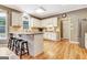 Bright kitchen with white cabinets, granite countertops, stainless steel appliances, and hardwood floors at 111 Biltmore Trce, Peachtree City, GA 30269