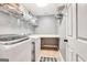 Functional laundry room with a folding table, shelving, and washer and dryer at 111 Biltmore Trce, Peachtree City, GA 30269