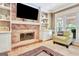 Inviting living room showcasing a brick fireplace, built-in shelving, and cozy seating area at 111 Biltmore Trce, Peachtree City, GA 30269