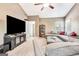 Inviting living room features a large sectional sofa, ceiling fan, and entertainment center at 111 Biltmore Trce, Peachtree City, GA 30269