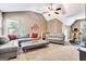 Cozy living room with two couches, a large ottoman and a ceiling fan at 111 Biltmore Trce, Peachtree City, GA 30269