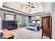Spacious main bedroom showcasing a tray ceiling, elegant furniture, and lots of natural light at 111 Biltmore Trce, Peachtree City, GA 30269