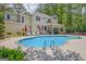 Backyard oasis features a large inground pool, lounge chairs, and covered patio at 111 Biltmore Trce, Peachtree City, GA 30269