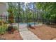 Gated pool surrounded by mature trees creates a backyard oasis at 111 Biltmore Trce, Peachtree City, GA 30269