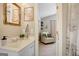 Cozy bathroom featuring light countertops, white cabinets, and a decorative gold mirror at 29 Clark Pl, Whitesburg, GA 30185