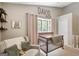 Charming bedroom with crib, love seat, and natural light at 29 Clark Pl, Whitesburg, GA 30185