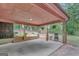Covered carport area with brick pillars and a view of the backyard and shed at 29 Clark Pl, Whitesburg, GA 30185