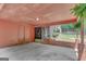 Covered carport with brick pillars and hanging ferns at 29 Clark Pl, Whitesburg, GA 30185