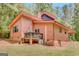 View of the back of the house with deck and brick foundation in a wooded setting at 29 Clark Pl, Whitesburg, GA 30185
