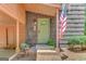 Charming front entrance with a covered porch, light-green door, and a patriotic American flag at 29 Clark Pl, Whitesburg, GA 30185