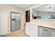 Open kitchen featuring stainless steel refrigerator and modern cabinetry, connecting to the living space at 29 Clark Pl, Whitesburg, GA 30185