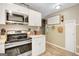 A pristine kitchen features white cabinets, stainless steel appliances, and modern countertops at 29 Clark Pl, Whitesburg, GA 30185