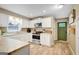 Well-lit kitchen featuring white cabinetry, stainless steel appliances, and wood-look floors at 29 Clark Pl, Whitesburg, GA 30185