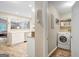 Functional laundry room with modern washer, shelving, and convenient access to the kitchen at 29 Clark Pl, Whitesburg, GA 30185