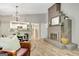Open-concept living area with brick fireplace, dining table, and kitchen view at 29 Clark Pl, Whitesburg, GA 30185