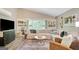 Cozy living room featuring a large window, comfortable seating, and built-in shelving at 29 Clark Pl, Whitesburg, GA 30185