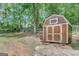 Exterior view of a storage shed with double doors in backyard at 29 Clark Pl, Whitesburg, GA 30185