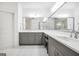 Bright bathroom with double vanity, gray cabinets, modern fixtures, and neutral countertops at 377 Parker Rd, Mcdonough, GA 30252