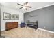 Cozy bedroom with light-colored carpet, dark blue accents, a changing table and a dark wood dresser at 377 Parker Rd, Mcdonough, GA 30252