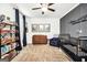 Modern bedroom with dark blue curtains, a changing table, crib, baseball decorations and light-colored carpet at 377 Parker Rd, Mcdonough, GA 30252