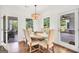 Charming dining room with wood floors, neutral decor, and view of screened-in porch at 377 Parker Rd, Mcdonough, GA 30252
