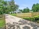Long driveway and fenced lawn leading to well-manicured home at 377 Parker Rd, Mcdonough, GA 30252