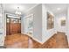 Elegant foyer featuring hardwood floors, a stylish chandelier, and a beautifully crafted wood door, creating a grand entrance at 377 Parker Rd, Mcdonough, GA 30252