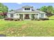 Charming home with a manicured lawn, rocking chair front porch, and inviting curb appeal on a sunny day at 377 Parker Rd, Mcdonough, GA 30252