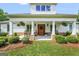 Charming home featuring a welcoming front porch with stylish columns, hanging plants, and manicured landscaping for curb appeal at 377 Parker Rd, Mcdonough, GA 30252