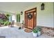 Inviting front porch boasts a decorative wreath, rocking chair, and potted plants, creating a cozy and welcoming entrance at 377 Parker Rd, Mcdonough, GA 30252