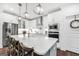Modern kitchen with a large island, pendant lights, stainless steel appliances, and a breakfast bar at 377 Parker Rd, Mcdonough, GA 30252