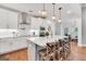 Spacious kitchen with a large island with seating, white cabinets, and modern appliances at 377 Parker Rd, Mcdonough, GA 30252