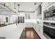 Spacious kitchen features white cabinets, a large island with a sink, and modern appliances at 377 Parker Rd, Mcdonough, GA 30252