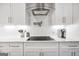 Bright kitchen features white cabinets, subway tile backsplash, quartz countertops, and stainless steel hood at 377 Parker Rd, Mcdonough, GA 30252