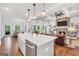 Bright open-concept kitchen with island and open view to the living room with brick fireplace at 377 Parker Rd, Mcdonough, GA 30252