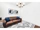Cozy living room features a leather sofa, decorative rug, stylish accents, and soft lighting, creating a relaxing ambiance at 377 Parker Rd, Mcdonough, GA 30252