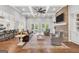 Open-concept living room featuring a brick fireplace, ceiling fan, and seamless flow to the kitchen, ideal for entertaining guests at 377 Parker Rd, Mcdonough, GA 30252