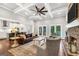 Spacious living room featuring a brick fireplace, hardwood floors, and open layout to the kitchen at 377 Parker Rd, Mcdonough, GA 30252