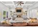 Cozy living room with brick fireplace, built-in shelves, ceiling fan and hardwood floors at 377 Parker Rd, Mcdonough, GA 30252