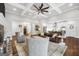 Open living space with hardwood floors, brick fireplace, and a seamless flow into the modern kitchen at 377 Parker Rd, Mcdonough, GA 30252