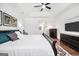 Bright main bedroom featuring a tray ceiling, ceiling fan, and dark wood furnishings at 377 Parker Rd, Mcdonough, GA 30252