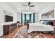 Spacious main bedroom featuring tray ceiling, hardwood floors, and a cozy sitting area at 377 Parker Rd, Mcdonough, GA 30252