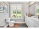 Powder room featuring wainscotting, hard wood floors and a window overlooking nature at 377 Parker Rd, Mcdonough, GA 30252