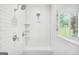Shower with a bench and dual shower heads in a white tiled enclosure at 377 Parker Rd, Mcdonough, GA 30252