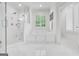 Bright bathroom featuring a walk-in shower with bench and a soaking tub with window at 377 Parker Rd, Mcdonough, GA 30252