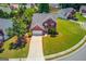 Aerial view of a beautiful brick home with a well-maintained lawn, driveway, and surrounding neighborhood at 2990 Haynes Club Cir, Grayson, GA 30017