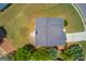 Drone shot of a brick house with a large roof, green lawn, and some trees in a suburban neighborhood at 2990 Haynes Club Cir, Grayson, GA 30017